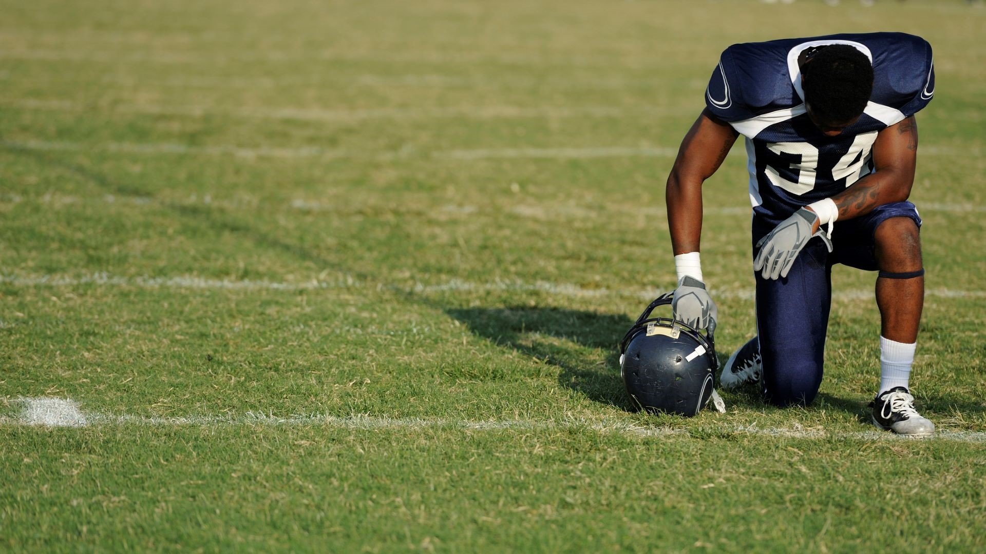 kneeling football player