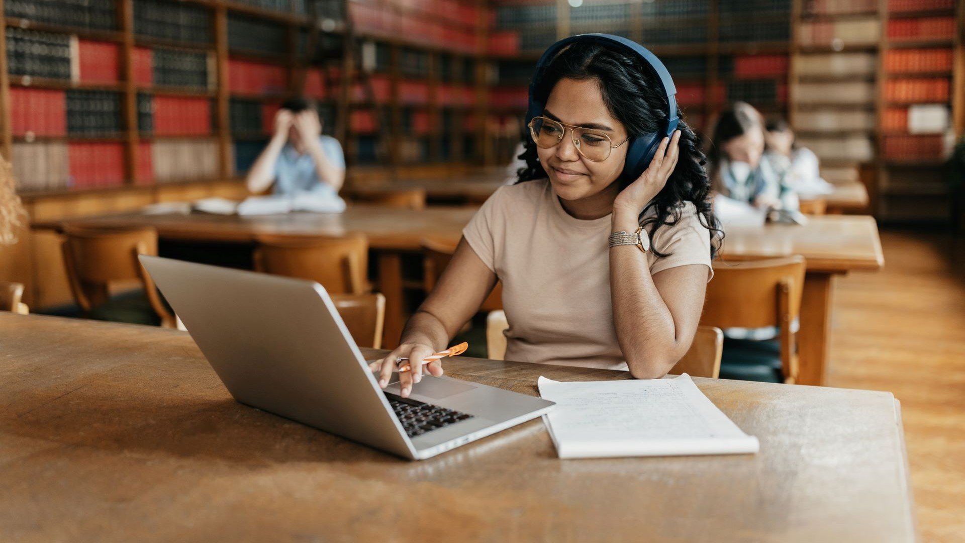 student on laptop with headphones