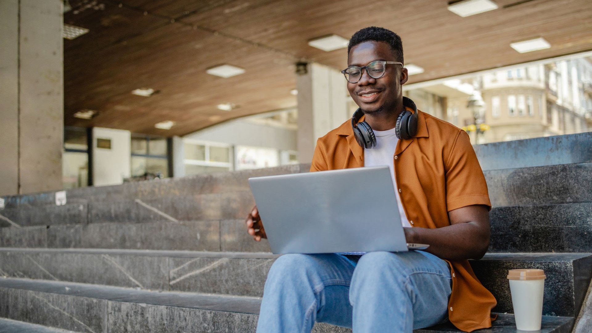 student sitting outside on laptop