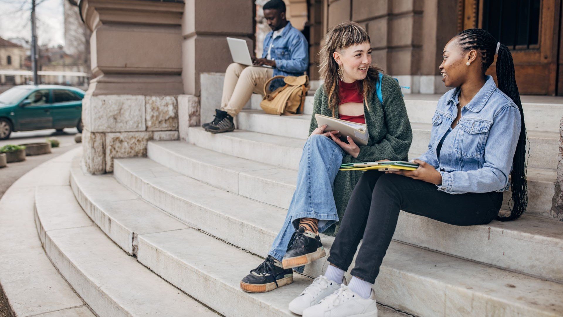 students sitting on building steps